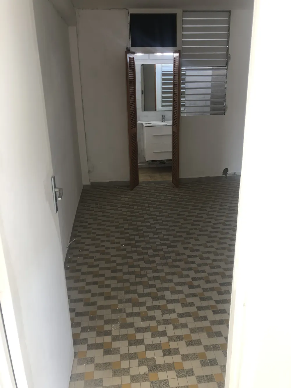 Couloir au carrelage mosaïque d’origine, persiennes en bois, avant travaux